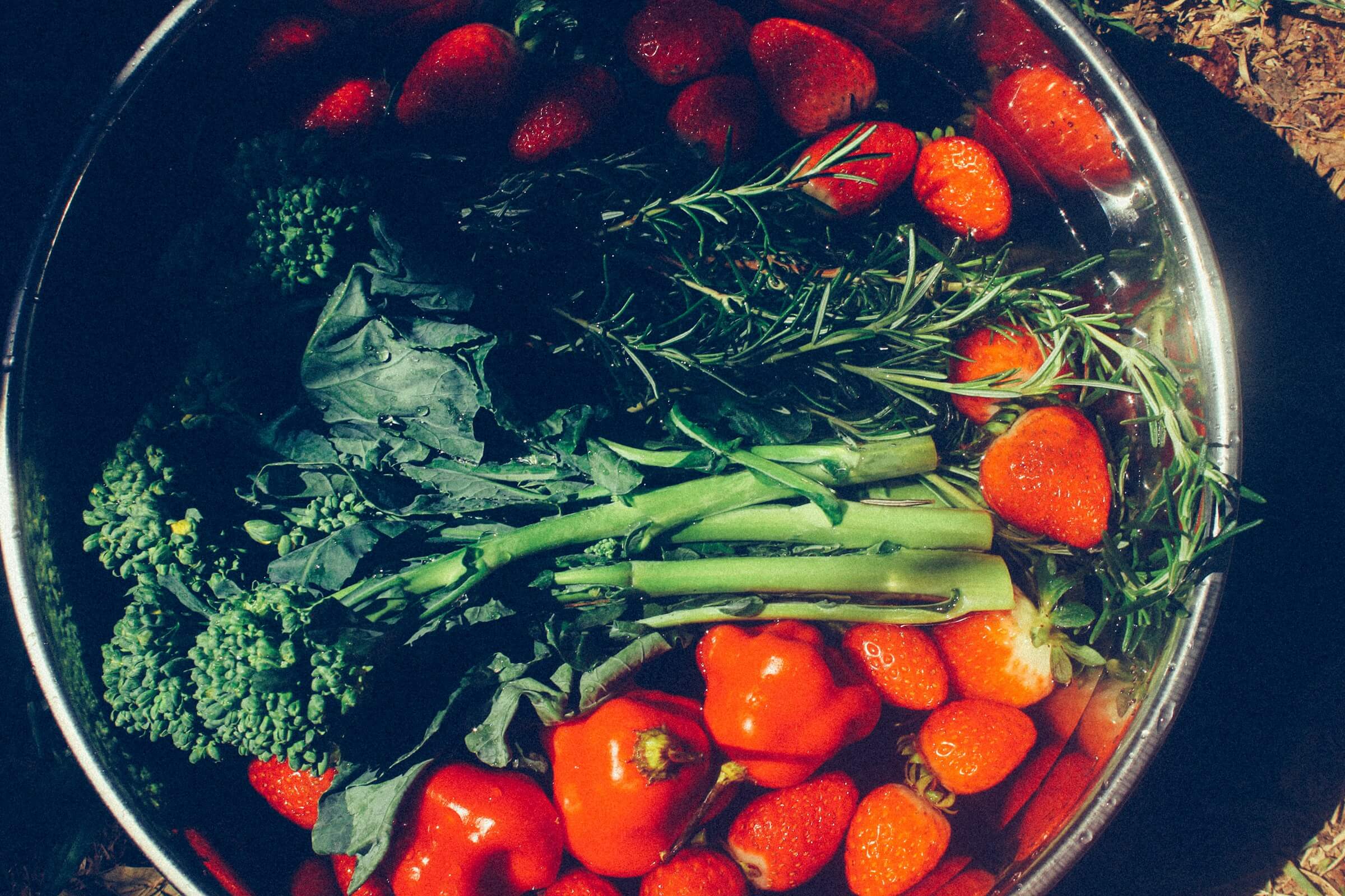 A bowl of fresh vegetables and fruits